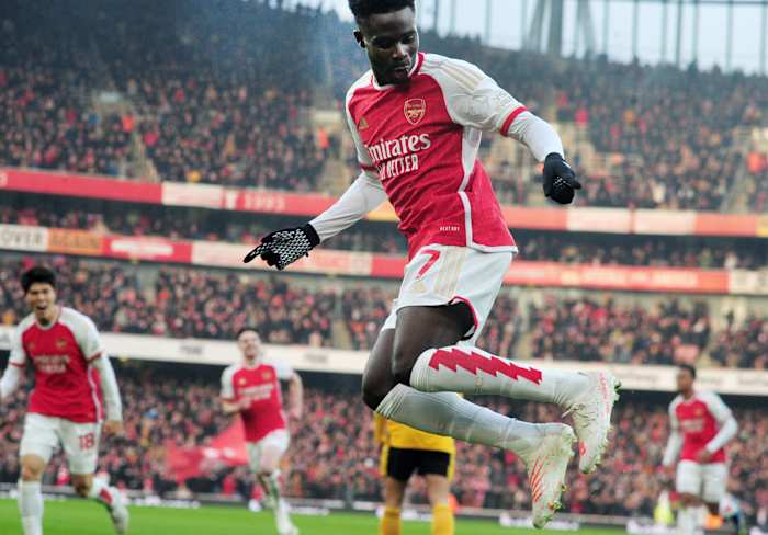 Bukayo Saka pictured celebrating after scoring for Arsenal in a 2-1 win over Wolves in December 2023
